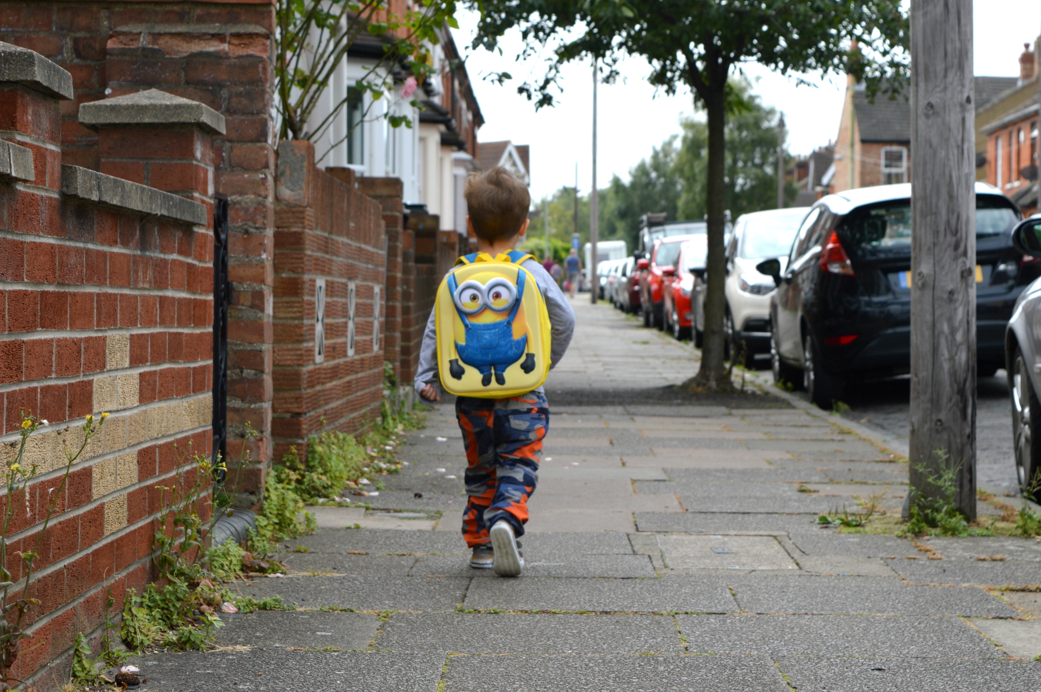 Little boy walking down the street There We Go